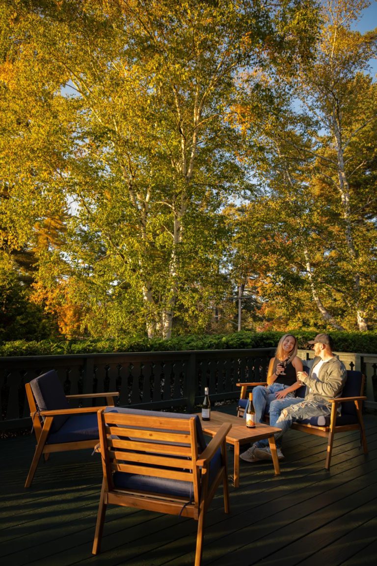 A couple sitting on a deck.