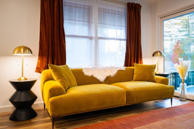 A yellow couch in a living room.