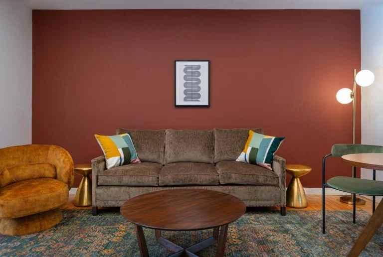 A living room with a brown couch and a coffee table.
