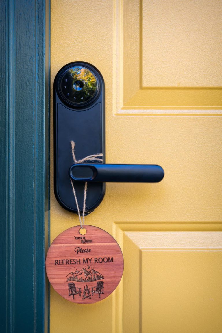 A wooden door handle with a sign that says 'find my door'.