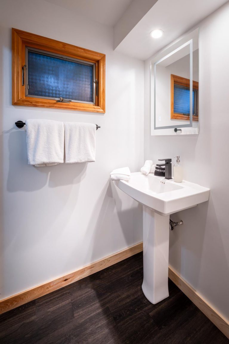 A bathroom with a sink and window.