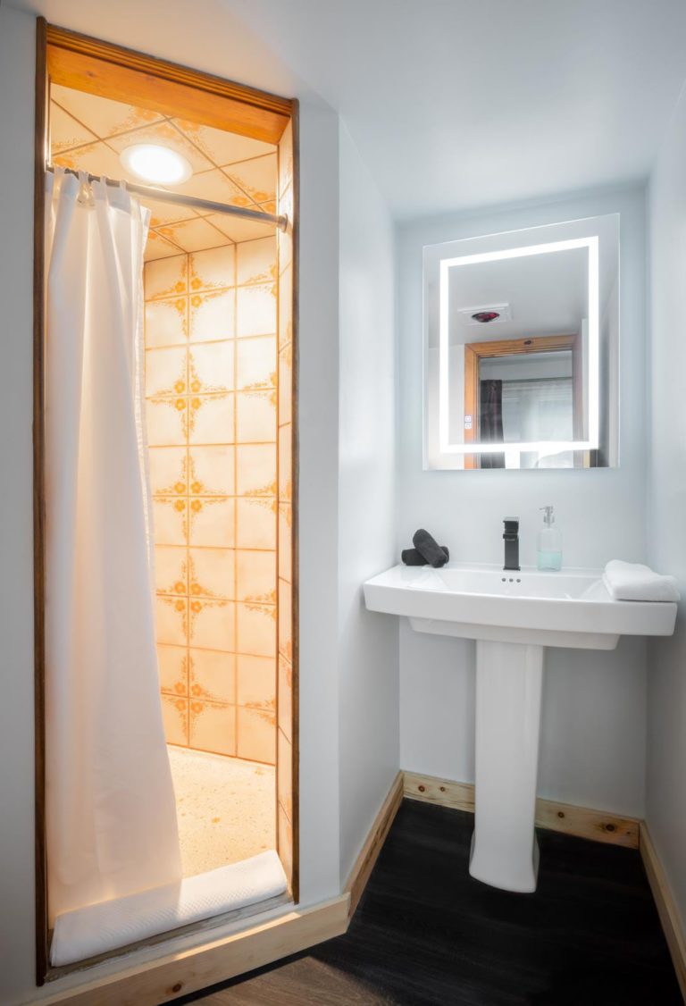 A bathroom with a shower and sink.